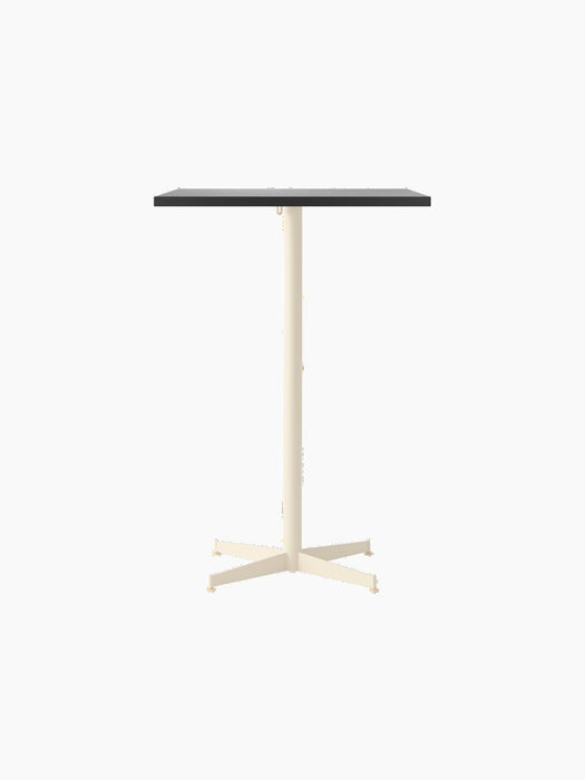 Front view of the Nook Bar Table, featuring a rectangular dark tabletop and a single pedestal ivory base with four legs.