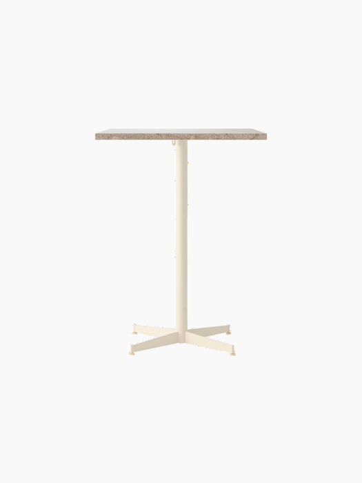Front view of the Nook Counter Table with a square Kunis Breccia stone tabletop and an ivory-coloured metal pedestal base.