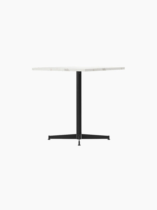 Nook Dining Table shown at an angle, with a square white marble top and a slender black powder-coated steel four-star base.