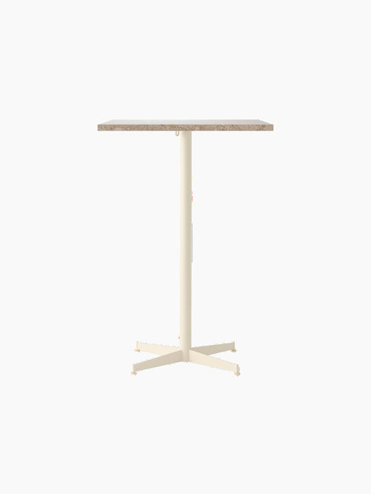 Front view of the Nook Bar Table, with a rectangular Kunis Breccia stone top and a slender, ivory powder-coated steel base.