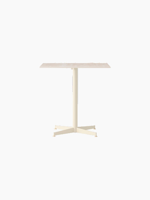 Front view of the Nook Dining Table with a rectangular Kunis Breccia stone top and ivory powder-coated steel four-star base.