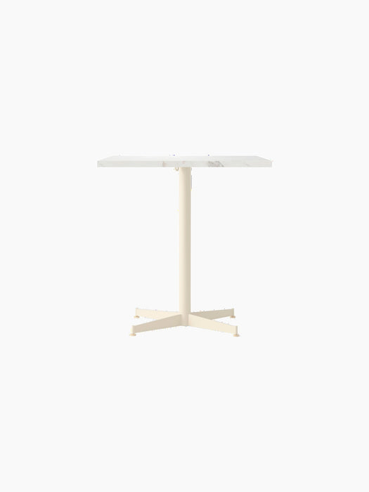 Front view of the Nook Dining Table with a rectangular Estremoz Marble top and an ivory powder-coated steel four-star base.
