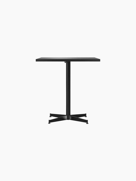 Front view of the rectangular Nook Dining Table in black oak veneer with a black powder-coated steel four-star base.