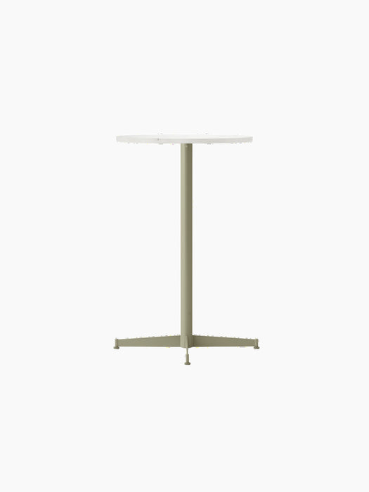 Angle view of the Nook Counter Table with a round Estremoz marble top and a slender, olive green powder-coated base.