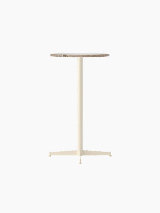 The Nook Bar Table with a round Kunis Breccia stone top and a four-legged pedestal base in ivory powder-coated steel.