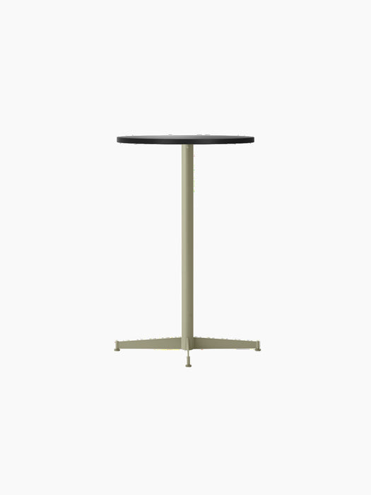 Angled view of the Nook Counter Table with a circular charcoal linoleum top and slender olive metal pedestal base.