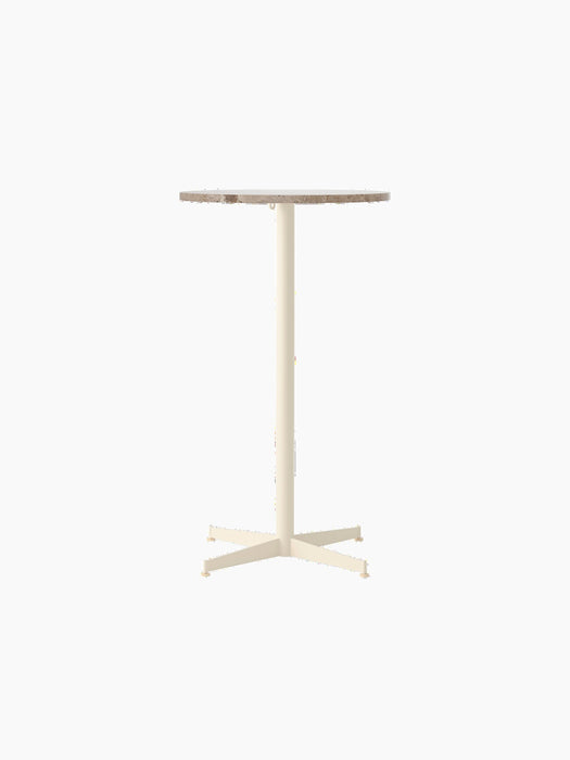 Front view of the Nook Bar Table with a round Kunis Breccia stone tabletop on a slender, ivory powder-coated steel base.