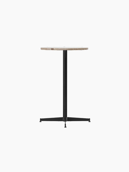 Nook Counter Table shown from an angle, with a circular Kunis Breccia stone top and a slim, black powder-coated steel base.