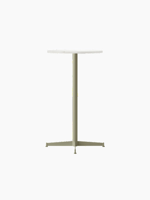The Nook Bar Table with a round Estremoz marble top and an olive green base, shown from an angle against a black background.
