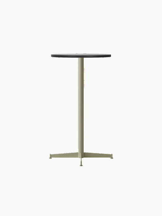 Angled view of the Nook Bar Table with a round black oak top on an olive green powder-coated steel column and cross base.