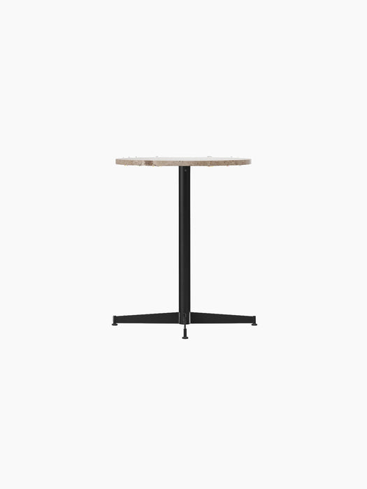 Angled view of the Nook Dining Table with a round Kunis Breccia stone top and a slender black metal four-star base.