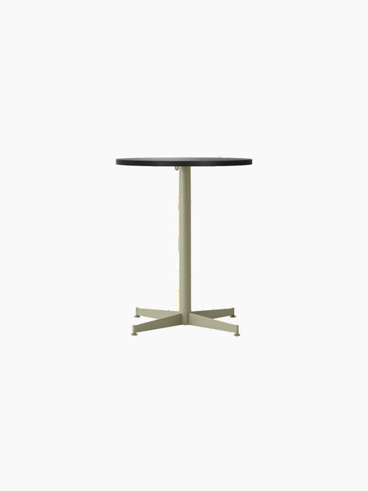 Front view of the Nook Dining Table with a round, charcoal linoleum top and a slim, olive green four-star steel base.