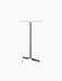 Front view of the Nook Bar Table with a round white Estremoz marble top and a tall, black powder-coated steel base.