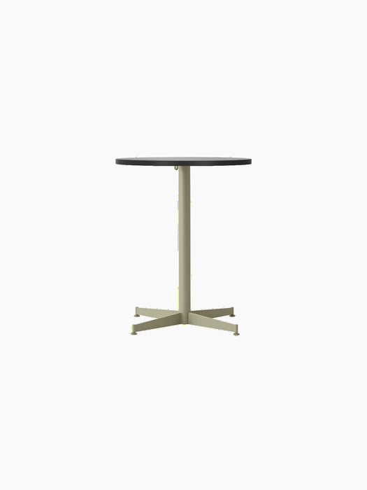 Front view of the Nook Dining Table, featuring a round black oak tabletop and a slim, olive-coloured four-star steel base.