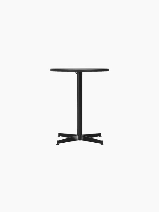 Front view of the Nook Dining Table with a round black oak top and a slender black powder-coated steel four-star base.
