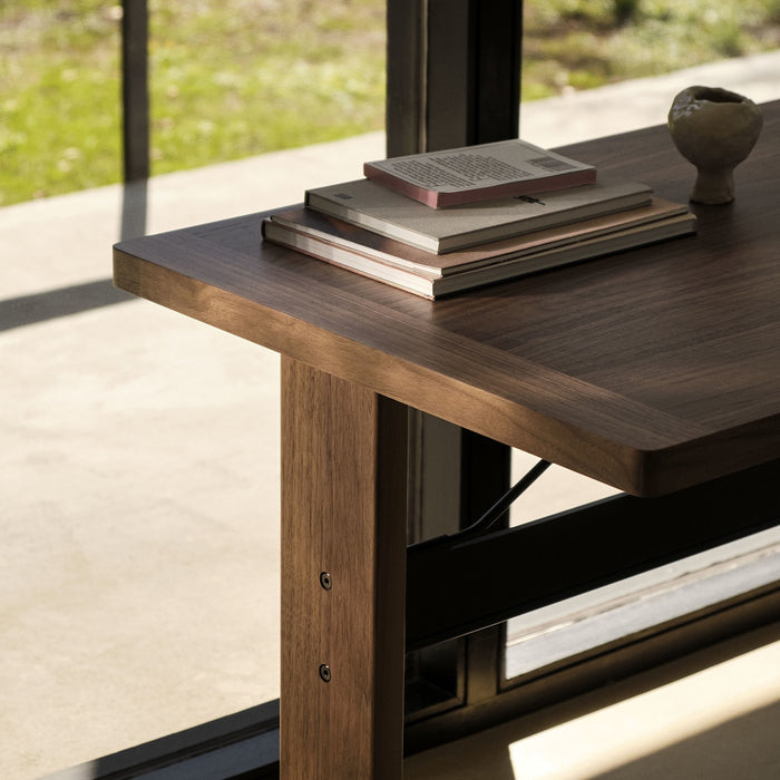 Passerelle Desk Water-based lacquered walnut frame Ink black powder coated crossbar Adjustable gliders - HAY