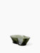 Aer Bowl, an organically shaped dark green glass vessel featuring an undulating rim and an internal swirl of white marbling.