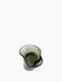 A top-down view of the Aer Bowl, a sculptural vessel of smoky green glass with an undulating, dark-edged rim.