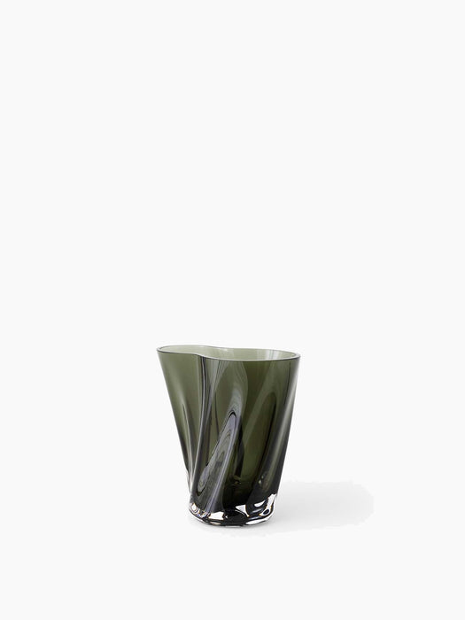 Front view of the sculptural Aer Vase 19 in dark green glass. The vase has a twisted, rippled form and a thick, clear base.