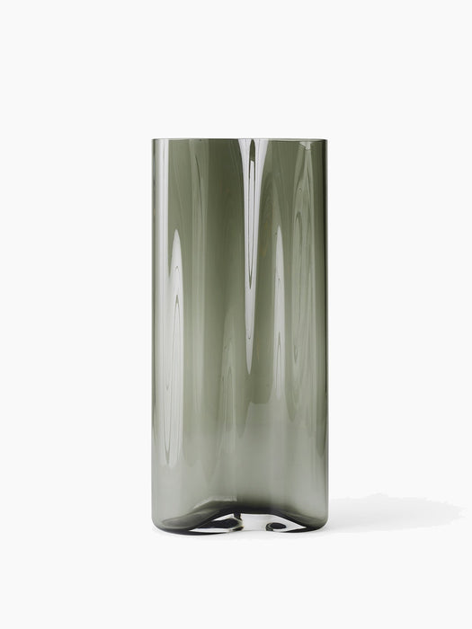 The tall, cylindrical Aer Vase Large, shown in smoky grey glass with a rippled surface texture, against a white background.