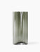 The tall, cylindrical Aer Vase Large, shown in smoky grey glass with a rippled surface texture, against a white background.