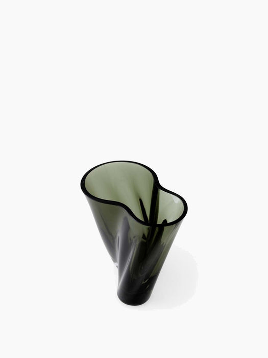 A top-down view of the dark green glass Aer Vase, showcasing its sculptural, undulating form against a white background.