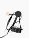A small Afteroom Coat Hanger in black and brass, with a black and silver Olympus camera hanging by its strap from the hook.