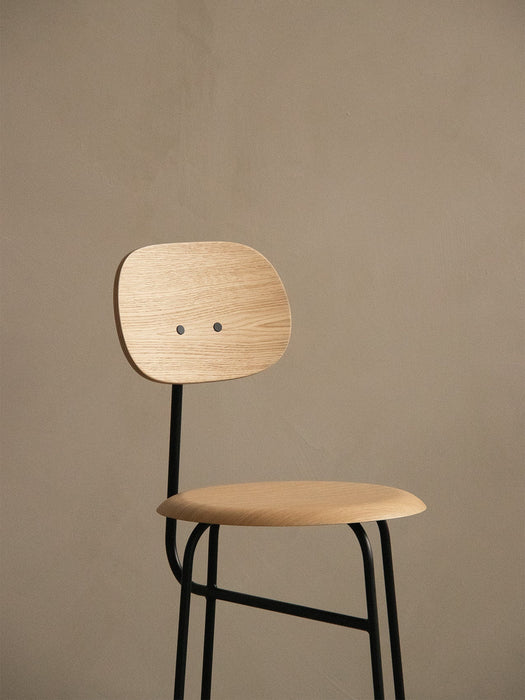A close-up of the Afteroom Counter Chair Plus with a natural oak veneer seat and backrest, set against a neutral-toned wall.