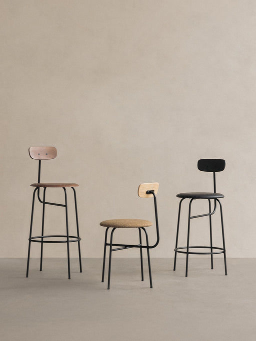 Three Afteroom chairs: a Counter Chair with a wood seat, a Dining Chair with upholstery, and a black Bar Chair.