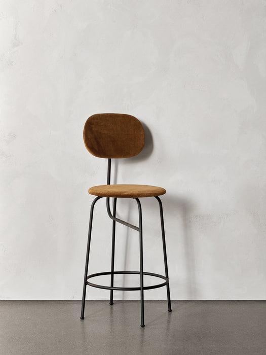 A frontal view of the Afteroom Counter Chair Plus, featuring brown upholstery and a slender black powder-coated steel frame.