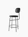 A black Afteroom Counter Chair Plus, shown at an angle, with a thin metal frame, a round upholstered seat and backrest.