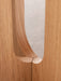 A close-up detail of the Androgyne Dining Table's sculptural base, showing the fine joinery and natural oak wood grain.