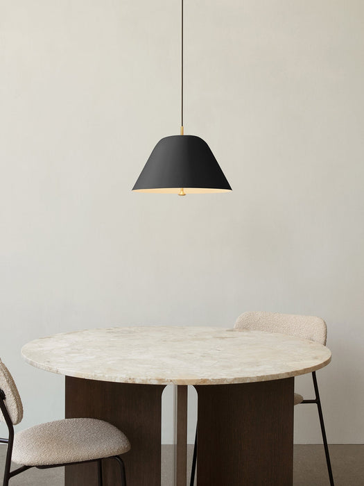 A black Levitate Pendant hangs over the round Androgyne Dining Table with a marble top, flanked by two upholstered Co Chairs.