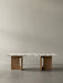 Front view of the Androgyne Lounge Table with a veined marble top on a natural oak wood base against a plain background.