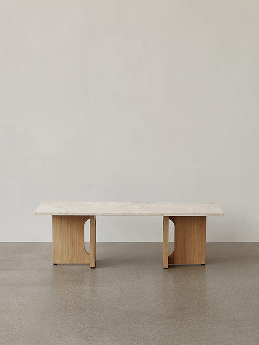Front view of the Androgyne Lounge Table with a natural oak wood base and a light-coloured Kunis Breccia stone tabletop.