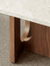 Close-up shot of the Androgyne Lounge Table, detailing the rich grain of the walnut wood base and its curved cut-out design.