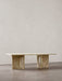 A front-facing shot of the Androgyne Lounge Table in Kunis Breccia stone, set against a neutral wall on a grey floor.