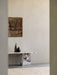 Androgyne Lounge Table in Calacatta Viola marble, styled with two vases, in a sunlit room with abstract art and a rug.