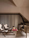A living room featuring the Androgyne Lounge Table with a Reverse Table Lamp, two Knitting Chairs and a Tailor Sofa.