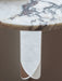 Close-up of the Androgyne Side Table, showing the detailed veining on its circular marble top and the sculptural white base.