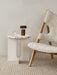 Androgyne Side Table with marble top and Column Table Lamp next to a shearling Knitting Chair on a Houkime Rug.