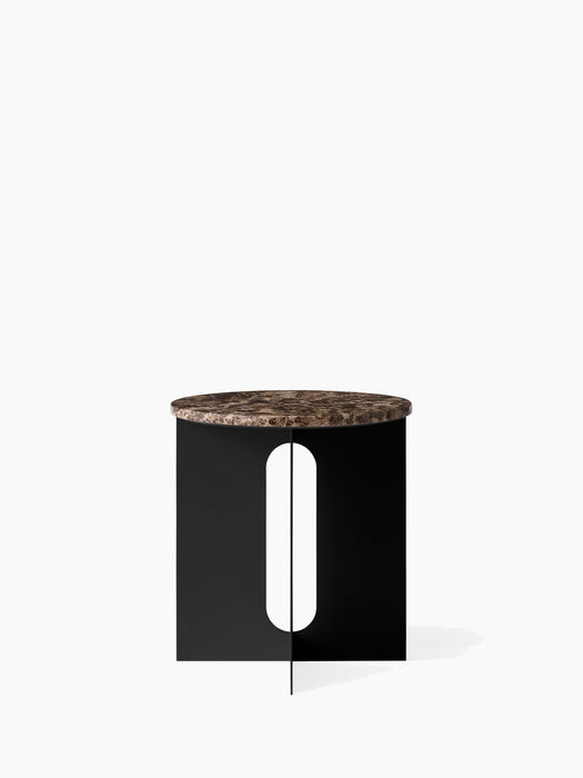 Front view of the Androgyne Side Table, featuring a round Emperador marble top on a black steel base with cutout details.