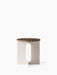 Front view of the Androgyne Side Table, featuring a round Emperador Marble top and an ivory base with a vertical cutout.