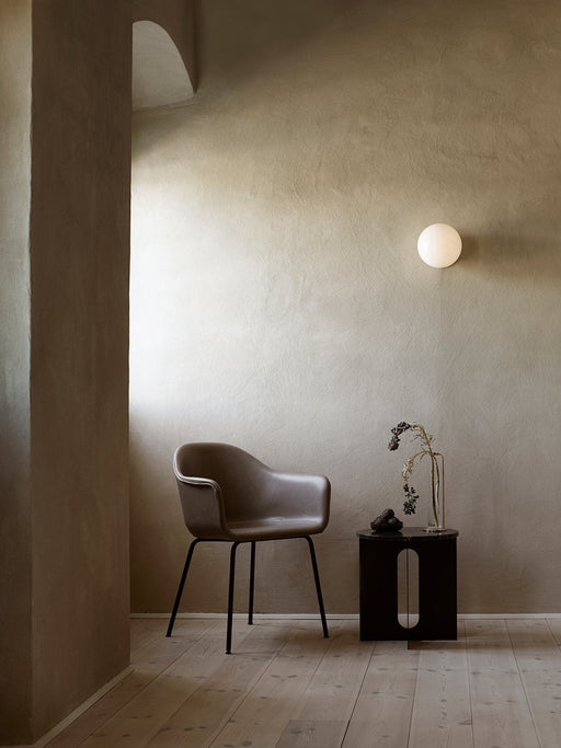 A tranquil scene with the Harbour Chair, Androgyne Side Table, Stem Vase, and TR Bulb wall lamp in a minimalist interior.