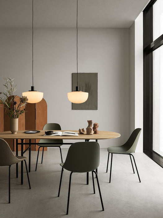 Two opal glass Bank Pendants hang over a Snaregade Table and Harbour Dining Side Chairs in a bright, modern dining room.