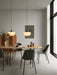 Two opal glass Bank Pendants hang over a Snaregade Table and Harbour Dining Side Chairs in a bright, modern dining room.