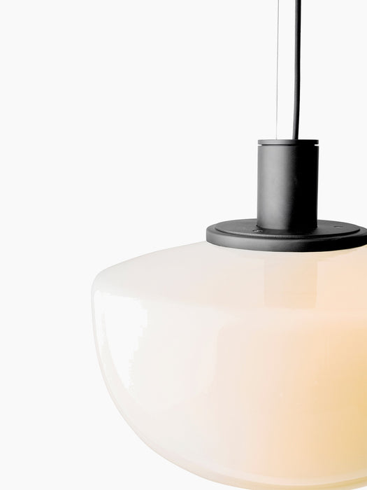 Close-up detail of the Bank Pendant's opal glass shade and black powder-coated aluminium fittings against a white background.