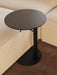 A high-angle, close-up view of the Branch Side Table in dark stained oak, its black base tucked next to a beige Eave sofa.