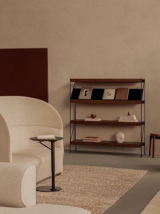 A Branch Side Table next to a Tearoom Sofa High Back, with a Zet Storage System and Passage Stool in a neutral-toned room.