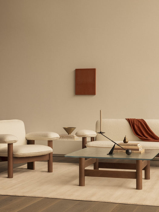 A neutral living room, cream Brasilia Lounge Chair and Sofa, Brasilia Lounge Table, and Interconnect Candle Holder.